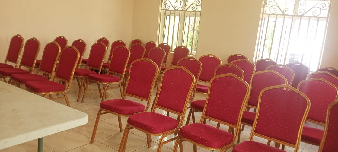 EmemUbong Breakout Room with rows of red chairs