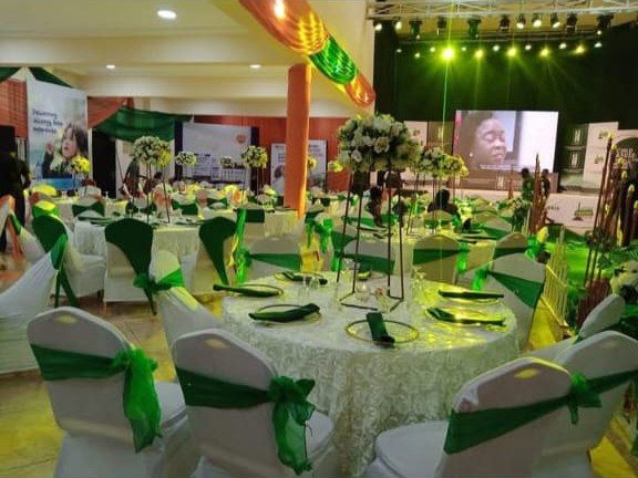Banquet hall with green sashes and stage lights