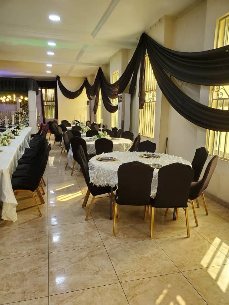 Black drapes and gold-legged chairs