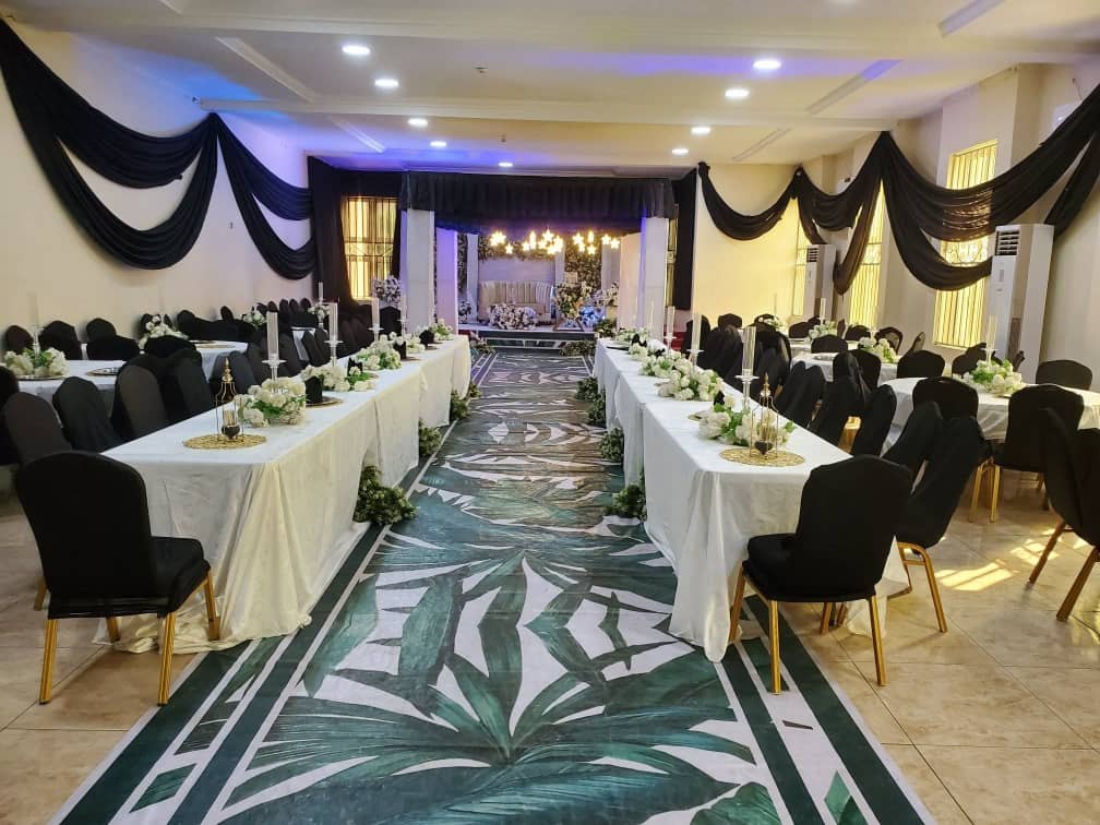 Hall with black drapes and leaf-print aisle