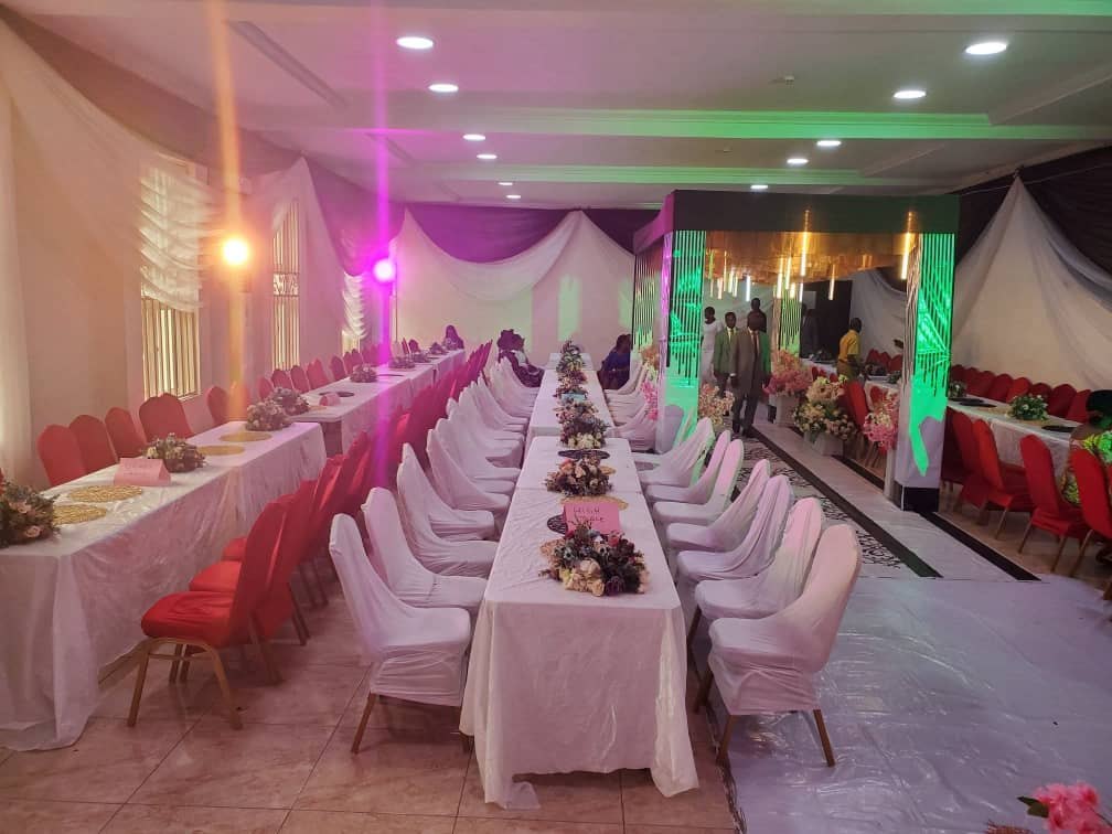 Long banquet tables with red chairs
