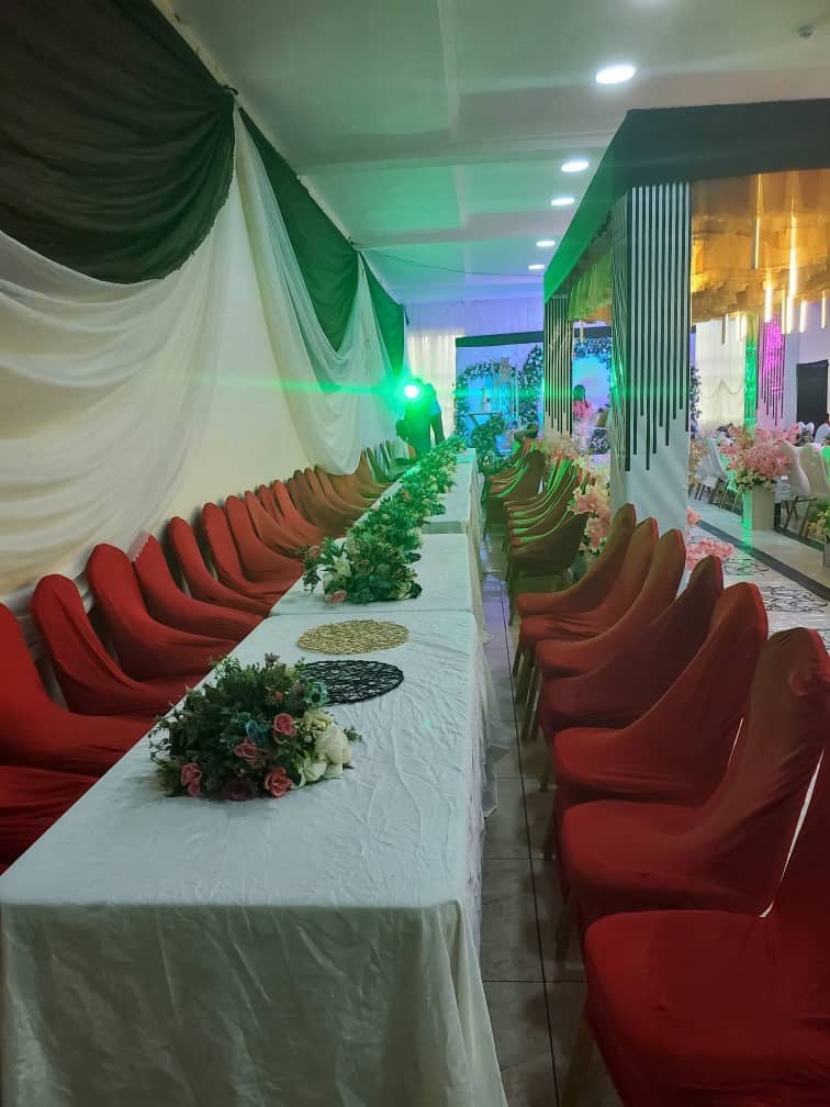Rows of red chairs along a banquet table