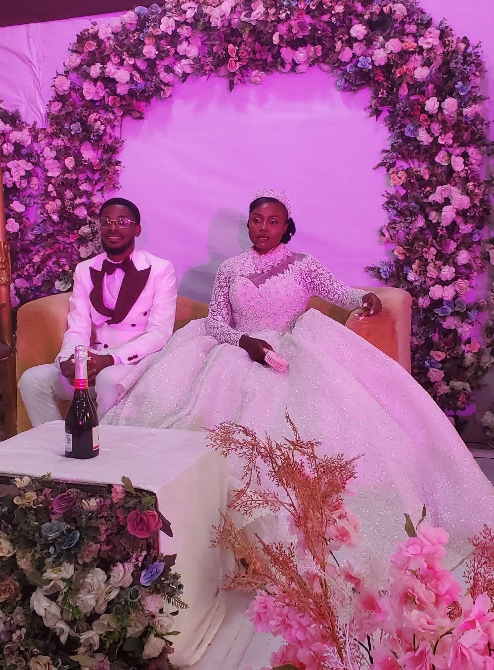 Wedding couple at a floral arch